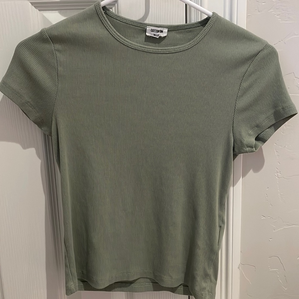 Green, ribbed t-shirt. Never worn, no rips or holes, in perfect condition